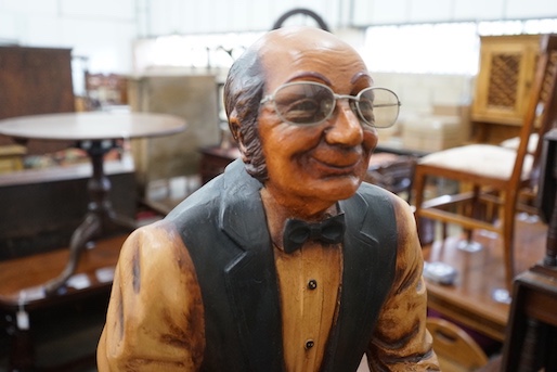 A painted composition dumb waiter in the form of an elderly butler, width 34cm, height 95cm